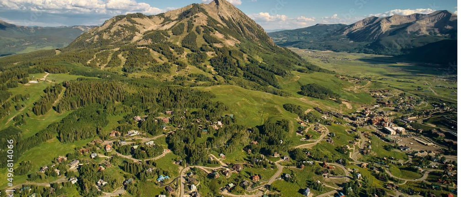 Aerial view of Mt. Crested Butte above the town and the Gunnison Valley in summer